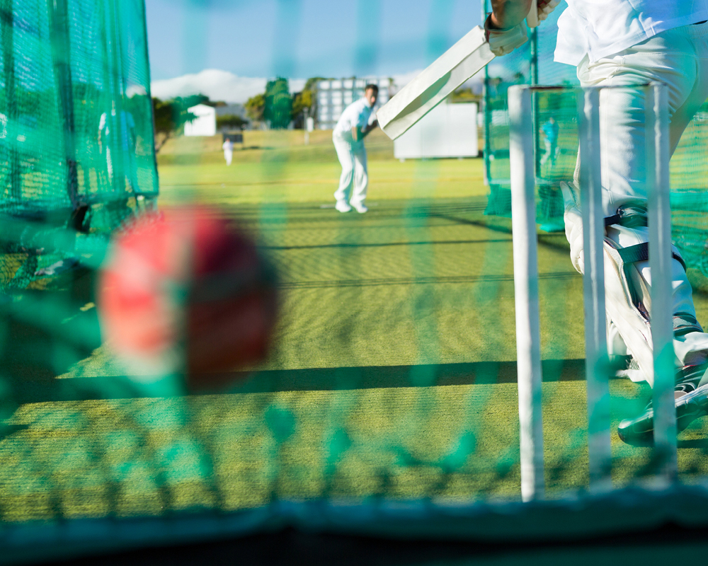 Bowler and batsman in cricket nets