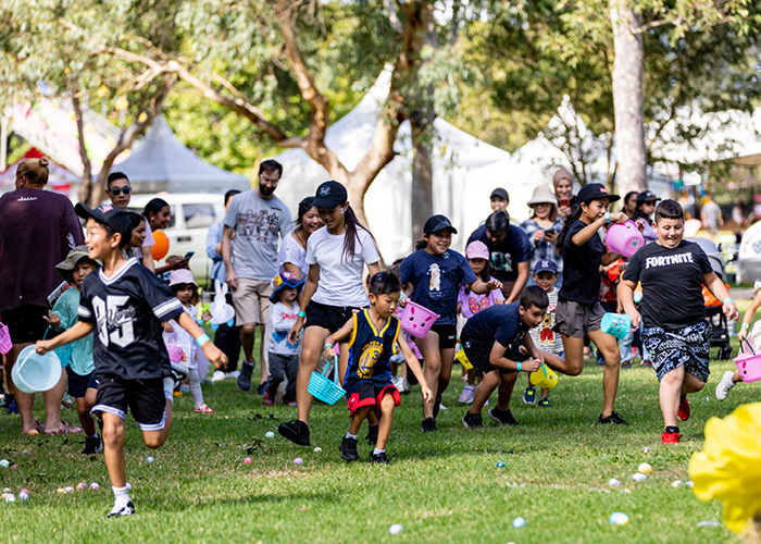 Children and adults scrambling at the Easter Egg hunt in Cumberland