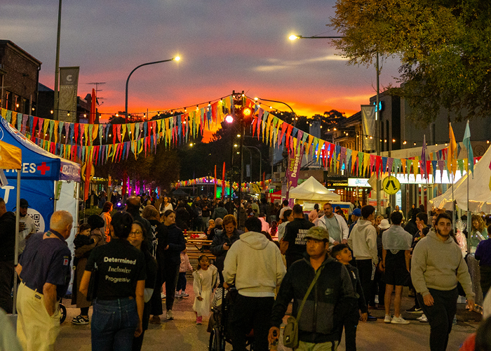 Crowds at the Back to Guildford Festival at sunset