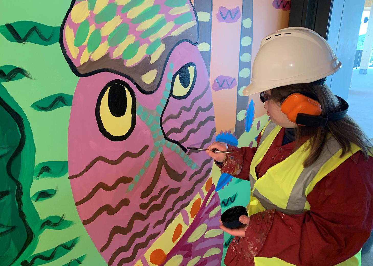 Artist Emily Crockford painting the Granville Stadium mural