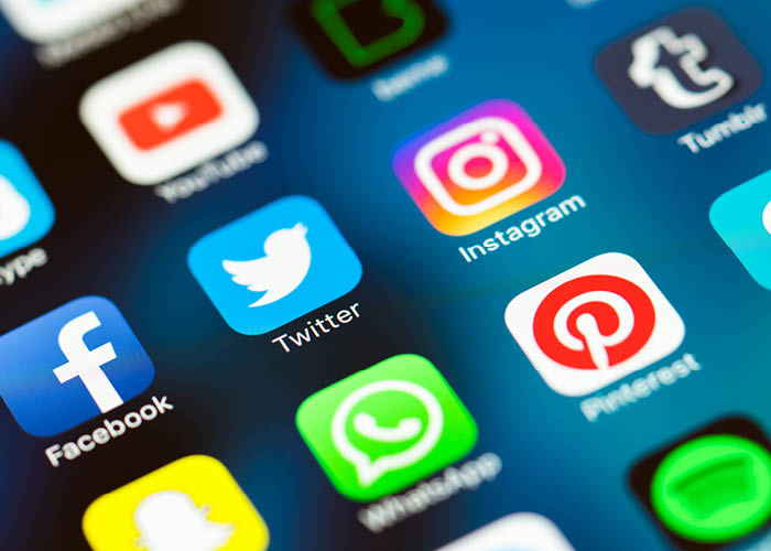 Close up of phone screen showing social media tiles