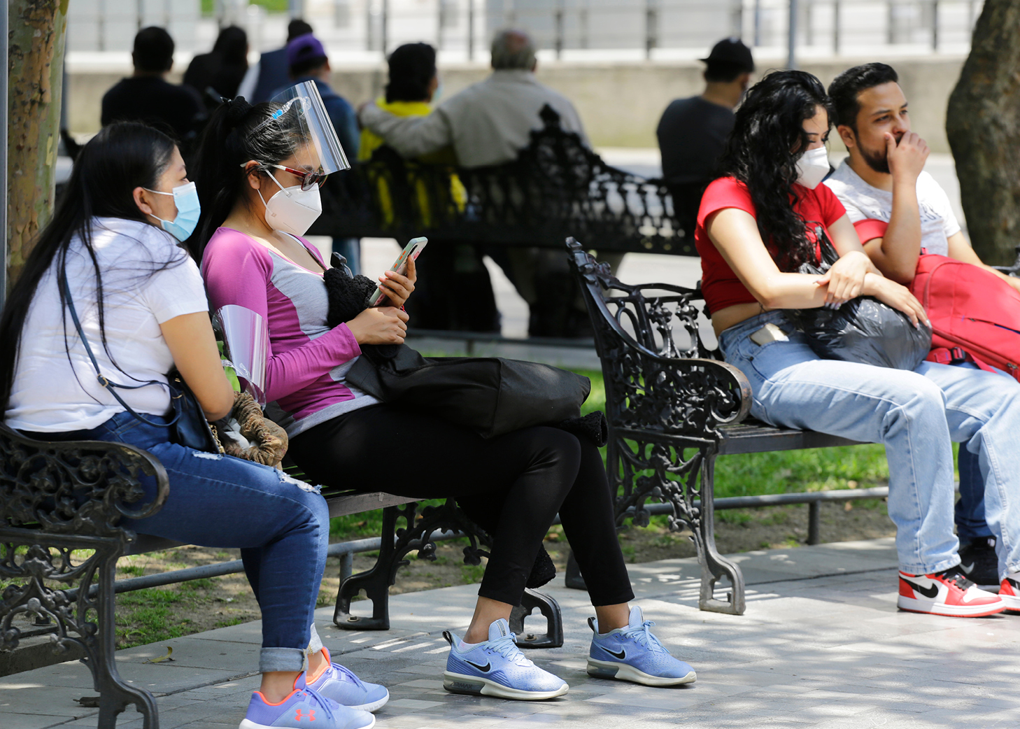 Social groups sitting outdoors with face masks