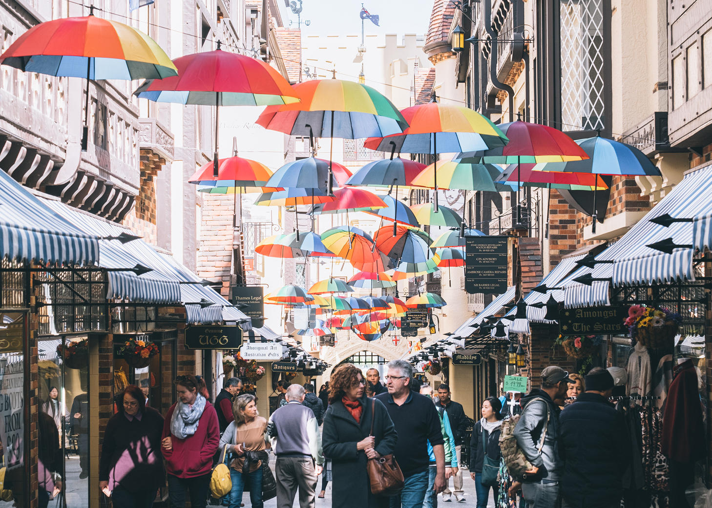 Street art in arcade with crowds